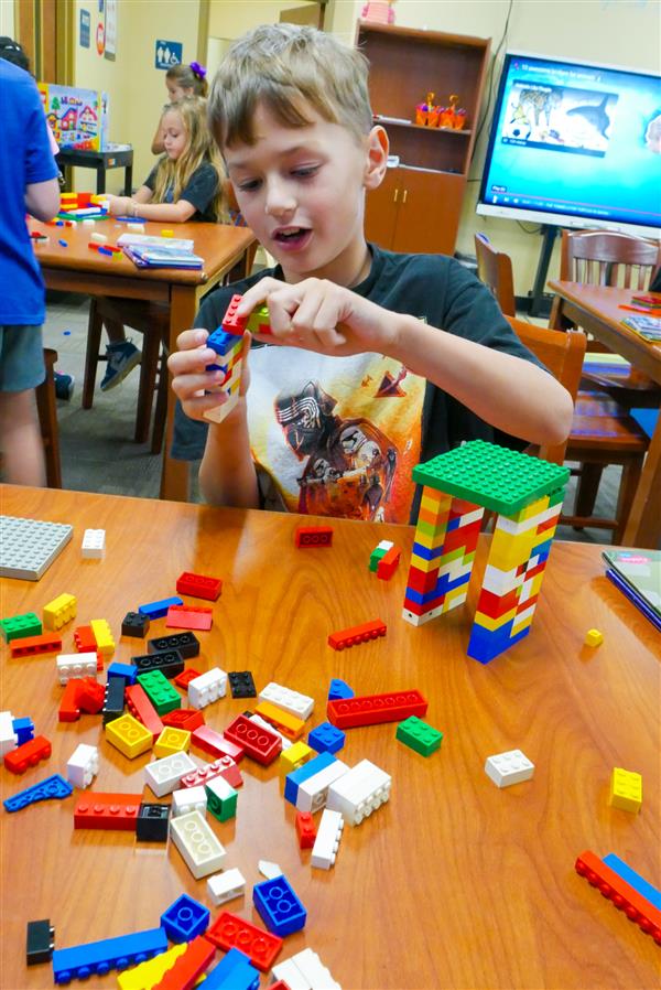 student with colorful block tower
